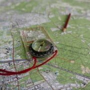 Recta kompas op een kaart Ontdek avontuur in Nationaal Park De Utrechtse Heuvelrug! Op de kaart, aangegeven met een recta kompas en route met een scherpe rode potloodstreep, vind je diverse bezienswaardigheden en terreinkenmerken. Klaar voor een langdurige ervaring? Trek je wandelschoenen aan en ga op pad!